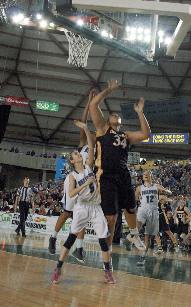 Inglemoor senior Deja Strother waits for her shot to fall through the hoop during the state title game at the Tacoma Dome on Saturday.