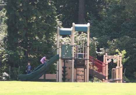 Kids play on the slide at Rhododendron Park last Friday.