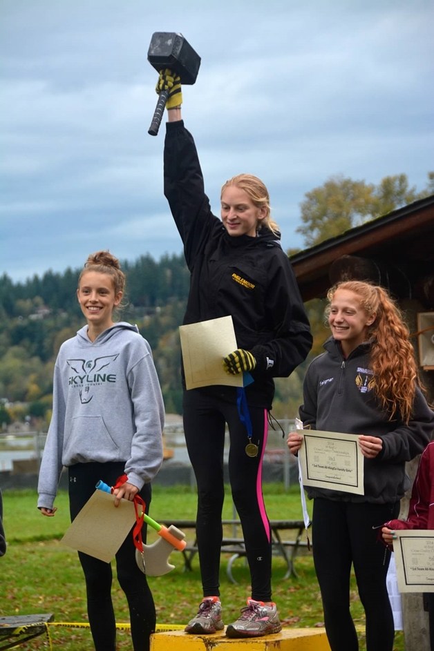 Inglemoor High School student Amber Rose stands atop the championship podium at the KingCo cross country meet.