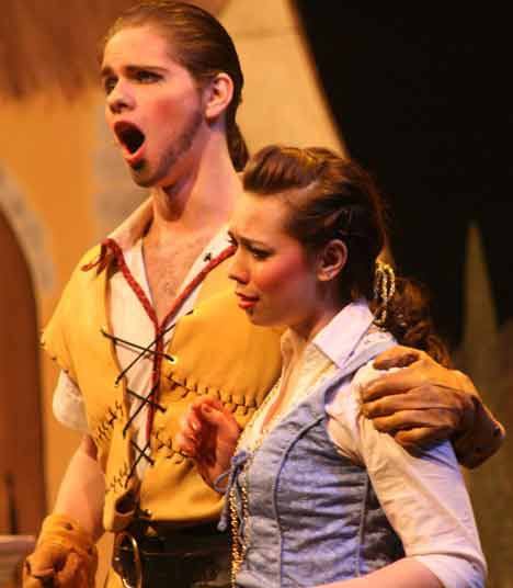 Inglemoor High students Joe Becker as Gaston and Meowset Abbett as Belle star in “Beauty and the Beast” Thursday at the Northshore Performing Arts Center. According to director Kevin Bliss