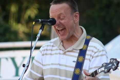 Danny Barnes gets intense while playing the banjo and singing his acoustic tunes Thursday evening at St. Edward State Park in Kenmore. He was accompanied by a guitarist and bassist. Next up at the free Kenmore Concert Series