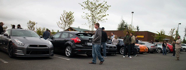 Participants in the May 16 Northwest Drivers Group meetup wander around and schmooze prior to heading out on the road.