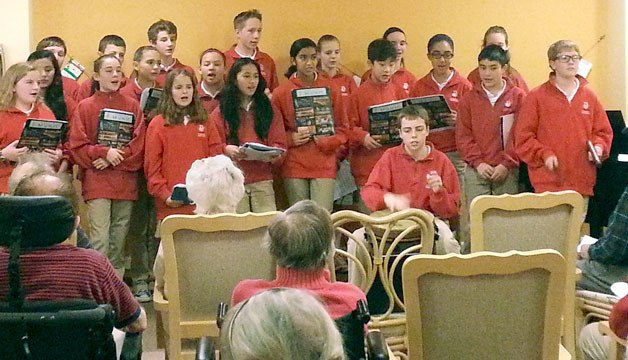 The seventh-grade class from St. Brendan Catholic School in Bothell sang a series of Christmas carols for the residents of the Chateau Retirement Community at Bothell Landing on Dec. 10.