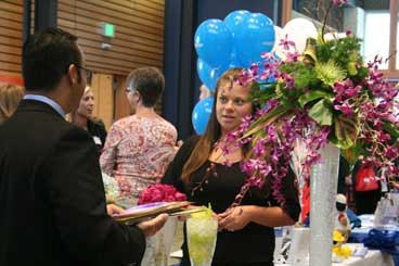 New Bothell Florist manager Laurel Stromme-Dede chats with BioLife Solutions' Aby Mathew at Wednesday's Greater Bothell Chamber of Commerce sixth-anniversary celebration in Mobius Hall at Cascadia Community College.