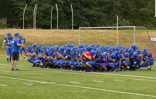 Bothell football head coach Tom Bainter rallies the troops during a recent practice at Bothell High School. The Cougars' season gets underway Friday night against the 4A defending champion Skyline Spartans