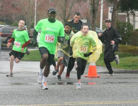 A pack of runners tackle the 5K run at Saturday morning's Can Do 5K/10K event at the Seattle Times North Creek building in Bothell. Numbered runners are