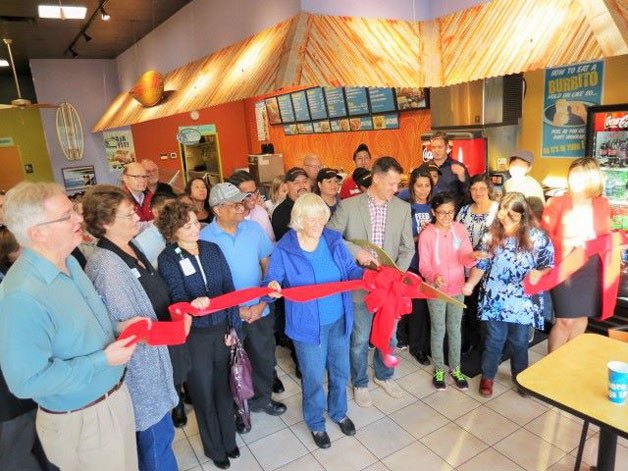 Bothell Mayor Joshua Freed cuts the ribbon at the new Taco Del Mar during a grand opening event presented by the Bothell Chamber of Commerce.