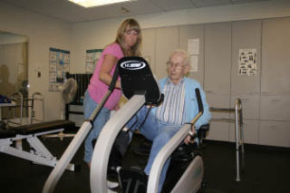 Certified nursing assistant Sue Leder helps adult day health participant Ray Renas
