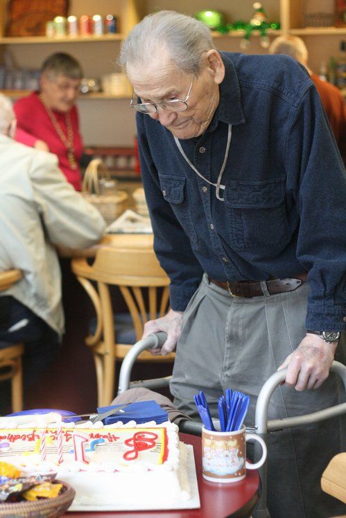 John Kasper eyes his 100th birthday cake this morning at the Northshore Senior Center. The party -- which featured two cakes -- took place after his Enhance Fitness class.