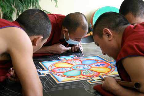A group of Tibetan monks from the Drepung Loseling Monastery in India create a sacred sand mandala in a spiritual exercise that honors impermanence Tuesday at Bastyr University.