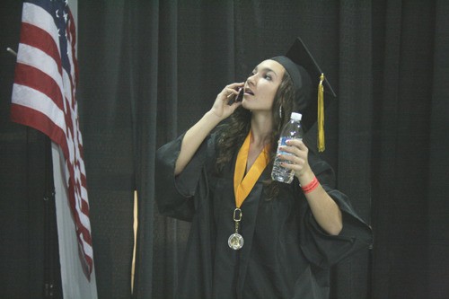 Inglemoor High's Brianna Gaines speaks on her cell phone as she searches for her family prior to last night's graduation ceremony at the University of Washington's Bank of America Arena. Inglemoor graduated 557 students.  Valedictorians were Eve Beausoleil