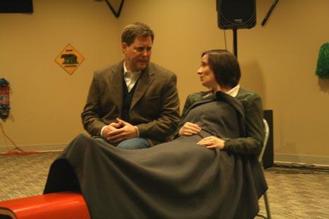 David Loventhal as author C.S. Lewis and Catherine Pigeon as Joy Gresham star in the Attic Theater production of “Shadowlands.” The pair rehearse here with Pigeon taking her place on a makeshift “hospital bed.”