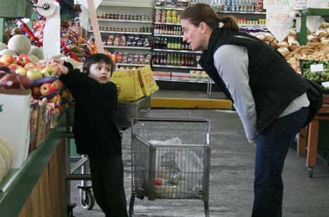 Theo and mom Karen Cooksey of Bothell discuss whether to grab some apples this morning at the Yakima Fruit Market at 17321 Bothell Way N.E. March 3 was opening day. Ken and Marie Lynch built the market in 1950