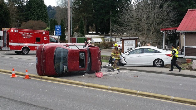 Emergency crews work at the site of this rollover collision on Highway 522
