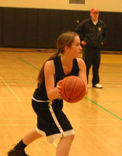 With coach John Augustavo looking on in the background