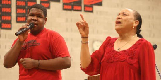 Total Experience Gospel Choir members Ray Dalton and Pastor Patrinell 'Pat' Wright sing for Kenmore Junior High students Friday morning as part of a Martin Luther King Jr. assembly. King's day to celebrate his life and achievements is Jan. 16.