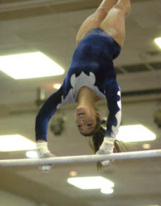 Bothell High’s Molly Michaluk performs on the uneven parallel bars at last weekend’s state  meet at the Tacoma Dome Exhibition Center. She finished sixth all-around. VINCE MILLER