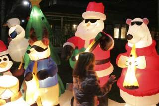 A child enjoys the Christmas music while checking out the blow-up ornaments at the Winterfest celebration at the Park at Bothell Landing last year.