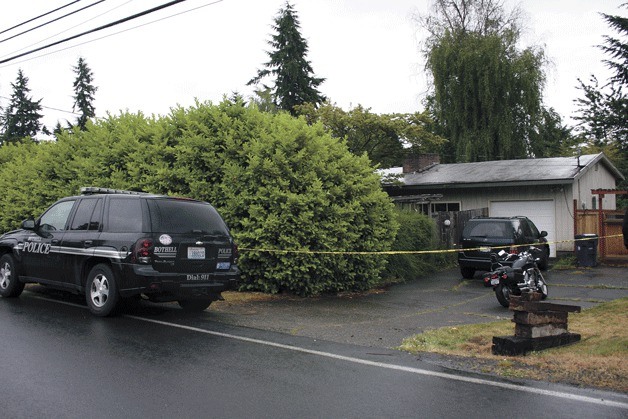 Alan Justin Smith was arrested Thursday morning at his home for obstructing justice after Bothell police served a search warrant for his passport and he refused to turn it over. Smith has been named as a person of interest in his estranged wife's murder