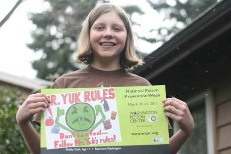 Kenmore’s Shelby Cole displays her winning Mr. Yuk poster at home.