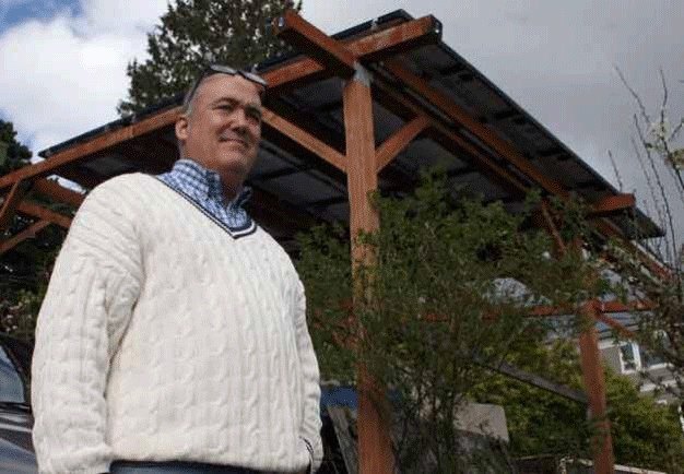 Kenmore resident Patrick O’Brien in front of his solar panel structure