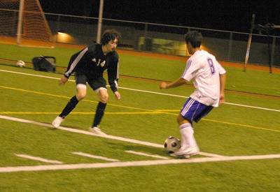 Bothell High's Mauricio Aguilar looks for an open man as Inglemoor junior Drew Svendsen defends during a  March 19 match that ended in a draw.