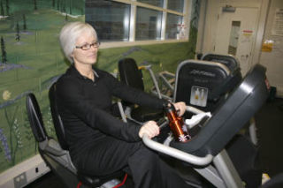 Denise Echelard powers through her second workout of the day on an exercise bike during a recent session of the Exercise and Thrive program.  TOM CORRIGAN