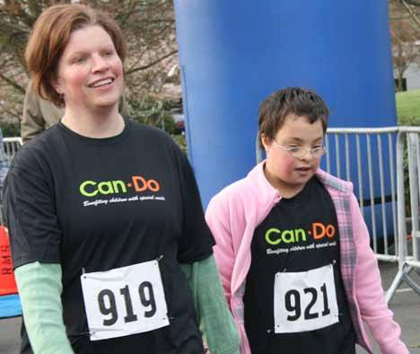 Jennifer and Mira Mostafavinassab cross the finish line in the 1-mile run/walk this morning at the Northshore Special Families' Can Do event at the Seattle Times building in Bothell. About 1