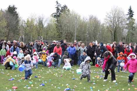 Children age 4 and under scramble for treats during last Saturday’s City of Kenmore Spring Egg Hunt at Inglemoor High. About 400 kids ages 12 and under and their parents attended the annual event. Kids also enjoyed inflatables