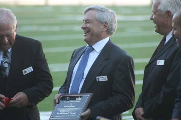 William Fassett enjoys a comment about him being an 'esteemed graduate of Ostroms' pharmacy as he's honored at last night's Wall of Honor ceremony at Pop Keeney Stadium.