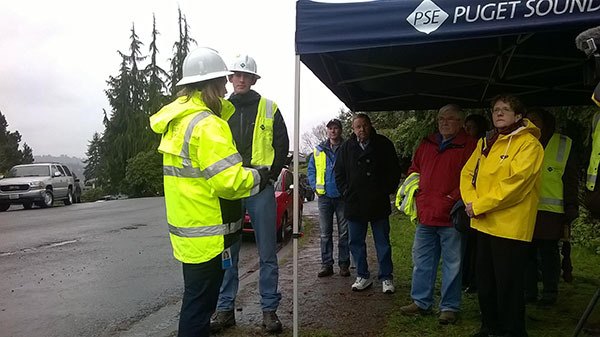 Puget Sound Energy representatives RaeLynn Asah (left) and engineer Mike Johnson (second from left) give an on-site presentation to Kenmore City Council members at the city's circuit 26