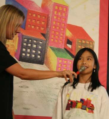 Google's Emma McKeithen interviews Woodmoor Elementary's Cindy Kuang today at an assembly.