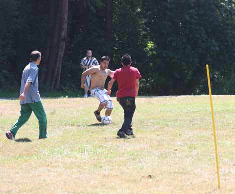 Friends soak up the sun and get in some soccer action last Friday at Blyth Park in Bothell.