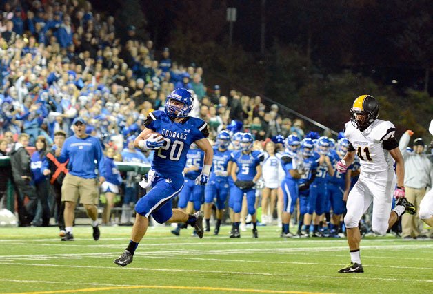 Bothell running back Sam McPherson breaks away from Inglemoor defenders for a 71-yard touchdown run during the annual Spaghetti Bowl between the two rivals. The Cougars finished the regular season 9-0 with the 55-0 win.
