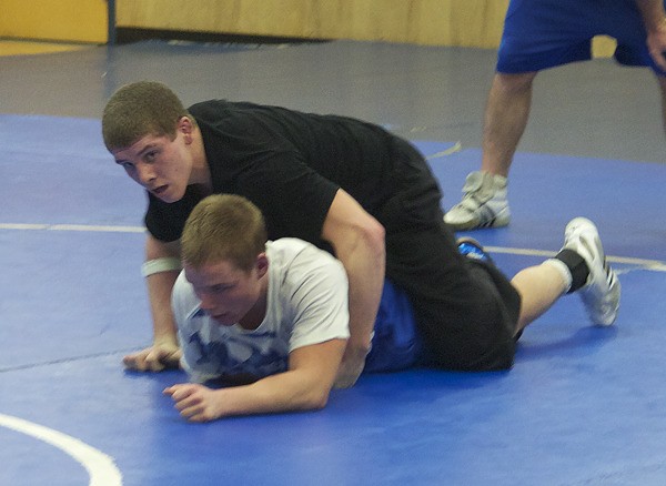 Junior captain Brandon Davidson (top) of Bothell High works on wrestling moves with teammate Dustin Rhode at a recent practice in the school's mat room. Davidson placed fifth last year at the state meet and hopes to advance to the title match this year.