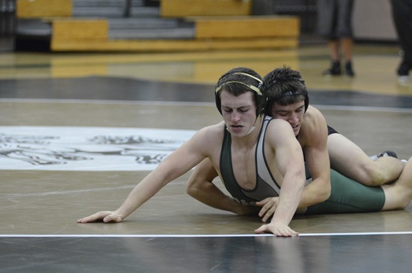 Inglemoor High senior captain Ian Bedo puts a hold on Redmond's Eli Grady during the 145-pound battle at a dual meet earlier this season. Bedo won the match