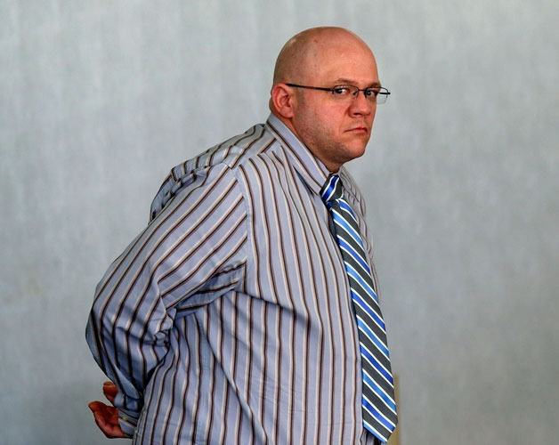 Joseph Strange waits for a deputy to handcuff him at the first break of his trial