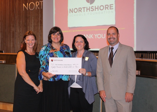 Northshore Schools Foundation director Carmin Dalziel (second from right) and president Sherry Krainick (second from left) presents a check for $80