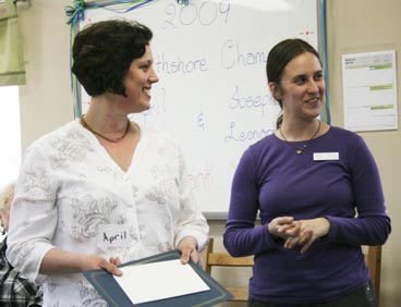 April Carl (pictured at left) and Joseph Leonard (pictured in slideshow) received 2009 Northshore Champions certificates Wednesday from Northshore Family Center Program Manager Rachel Borella at a tea party in Bothell. Carl and Leonard are two of the center's dedicated volunteers. The Northshore Family Center is a Center for Human Services program.