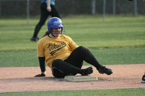 Inglemoor High's Amy Taylor sits near second base and laughs after falling during a slide at practice on Wednesday.