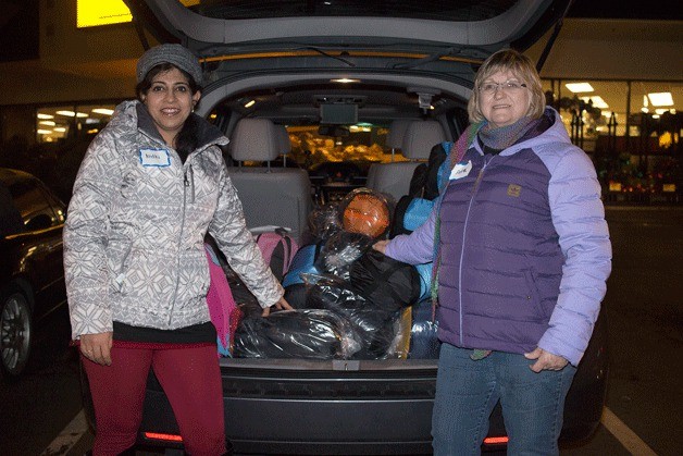 Nidhi Mehta (left) and Anna Evanger (right) worked from 4 to 9 p.m. to give sleeping bags and backpacks full of food to homeless people within Bothell and Kenmore