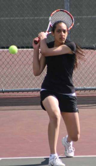 Inglemoor High’s Jasmine Singh fires the ball back at her Woodinville High opponent during last week’s match. Singh won at No. 1 singles