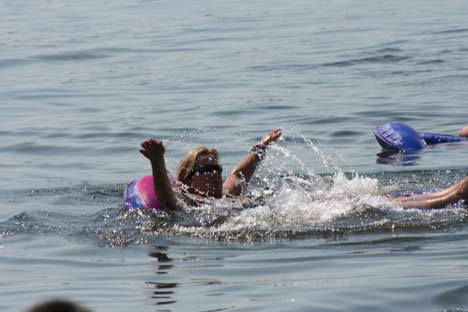Lori Nulton of Seattle splashes away on her 'floaty' in the 90-plus-degree heat this afternoon on Lake Washington just off Kenmore's Log Boom Park. 'It's way too hot