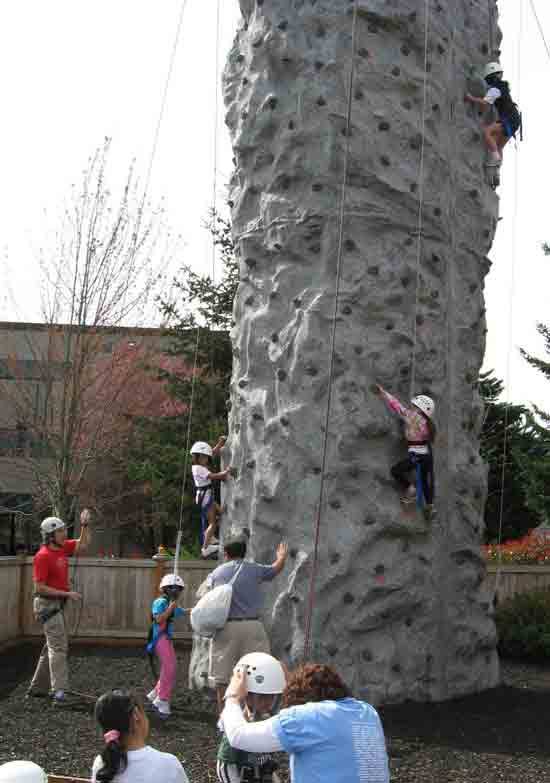 Kids scale the climbing tower at last year’s Healthy Kids Day at the Northshore YMCA.