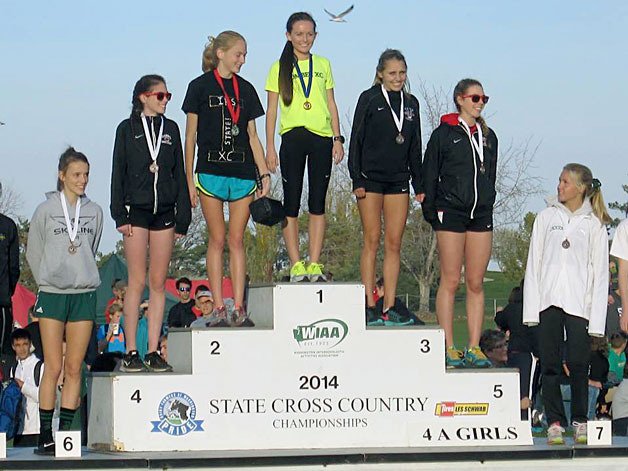 Inglemoor senior Amber Rose stands on the podium after receiving her medal for second at the State cross country meet in Pasco
