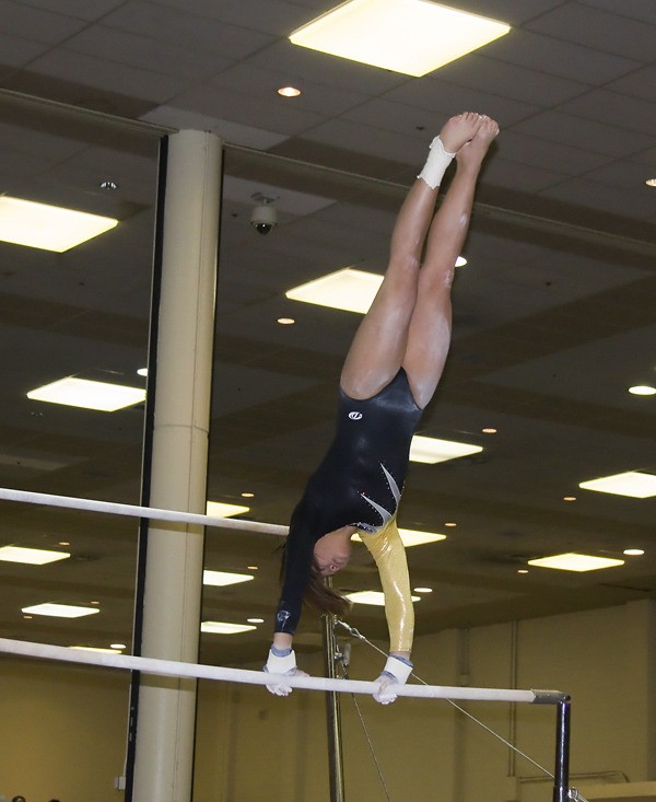 Inglemoor senior Mina Tanaka performs her bars routine during the Saturday finals of the 4A state gymnastics meet at the Tacoma Dome Exhibition Hall. Tanaka scored 9.125 on her routine to place fourth in the state and take home a medal.