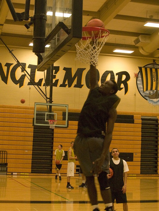 Senior forward Sam Omondi slams home a one-handed dunk during a recent practice at Inglemoor High. The 6-foot-5 senior and team co-captain is one of the Vikings’ post threats.
