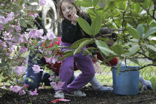 Melissa Parish gets tangled up in a bush as her mother