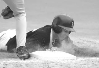 Inglemoor High sophomore Craig Jacobsen dives into first base during last week’s 4A Kingco matchup with Bothell High.