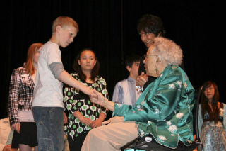Dorothy Johnson congratulates Hollywood Hill Elementary’s Grant Kamien on receiving his C.P. Johnson Humanitarian Award May 13 at the Northshore Performing Arts Center. Sen. Rosemary McAuliffe looks on from the far right.